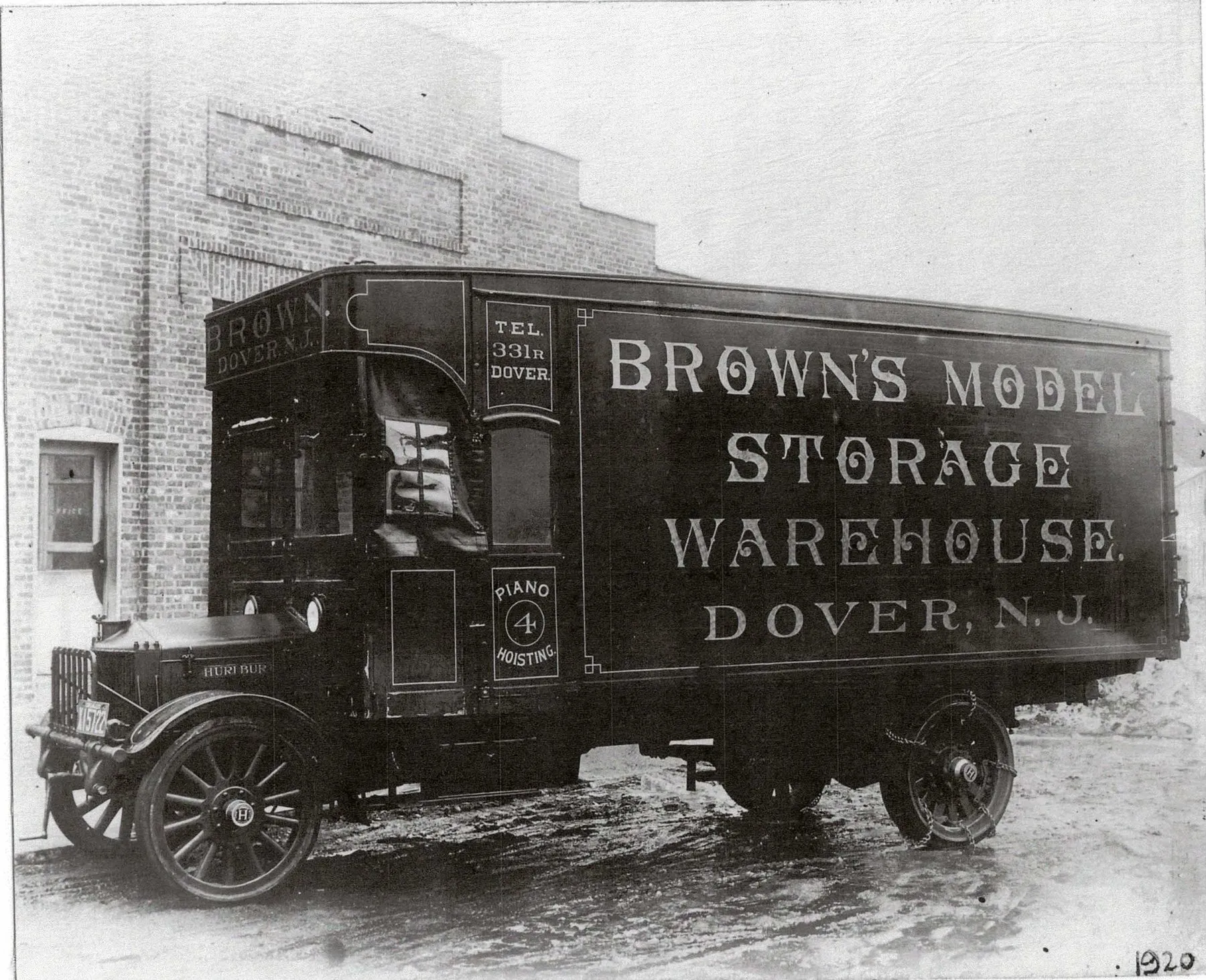 1920 - Solid tires and a chain drive. Still N. Sussex Street.